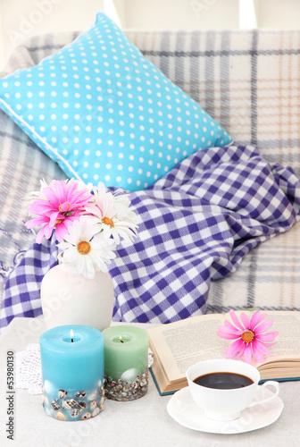 Fototapeta na wymiar Home interior background with sofa, plaid, flowers and cup