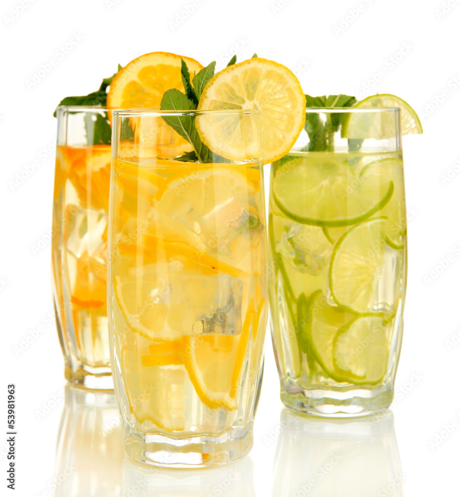 Glasses of fruit drinks with ice cubes isolated on white