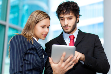 Poster - Two young businesspeople at work