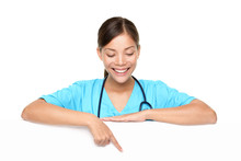 Young Female Doctor Pointing At Copyspace