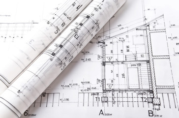 Architect rolls and plans project blueprint