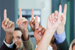 © michaeljung - business group raising hands