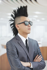 Well-dressed young man with Mohawk and sunglasses