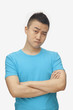 © xixinxing - Young man with arms crossed, studio shot