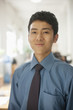 © xixinxing - Young man smiling in the office, portrait