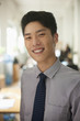 © xixinxing - Young man smiling in the office, portrait