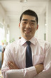 © xixinxing - Young man smiling in the office, portrait