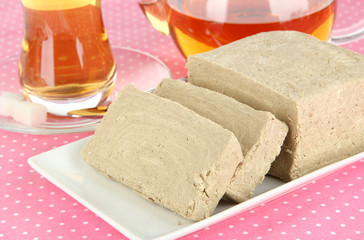 Wall Mural - Tasty halva with tea on table close-up