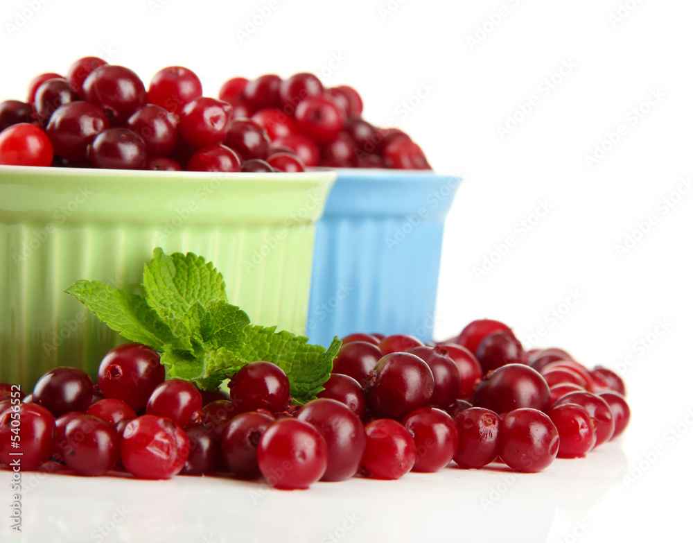 Ripe red cranberries in bowls, isolated on white.