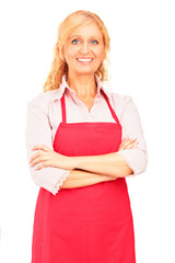 Canvas Print - Smiling mature female worker wearing an apron