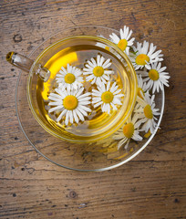 Sticker - chamomile tea on an old wooden table