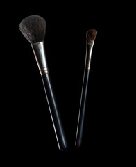 Wall Mural - Make-up brushes isolated on black background