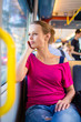 © lightpoet - Pretty, young woman on a streetcar/tramway
