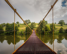 Metal Suspension Bridge Over The River