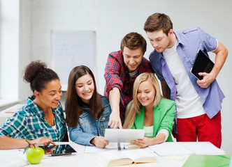Wall Mural - students looking at tablet pc at school