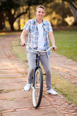 Wall Mural - teenage boy riding a bicycle