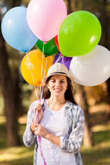 Wall Mural - teenage girl holding bunch of helium balloons