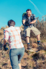 Wall Mural - Man Helping His Girlfriend Hiking