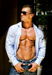 © theartofphoto - Attractive young muscle man outdoors with shirt open and jeans