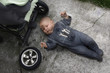 baby lying on the ground and repairing your stroller