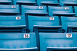 row of blue chairs in a stadium