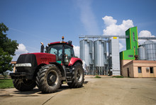 Tractor In Front Of Silos