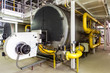 interior gas boiler room with large boilers and burners