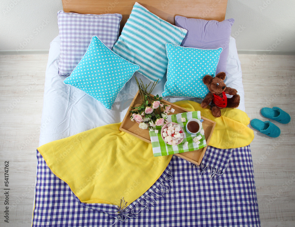 Bed with breakfast in room top view close-up