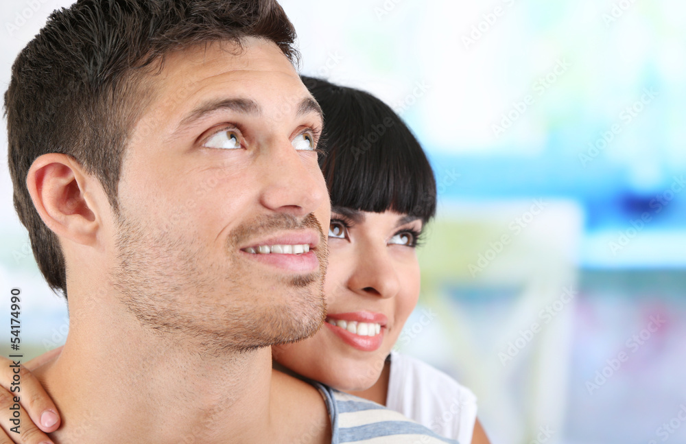 Beautiful loving couple together on bright background