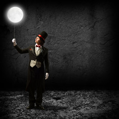 magician keeps the moon on a string