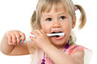© karelnoppe - Close up portrait of cute girl brushing teeth.