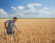© Ryzhkov Oleksandr - farmer standing in a wheat field