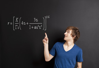 Young man pointing to a equation