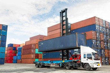 Crane lifting up container in yard