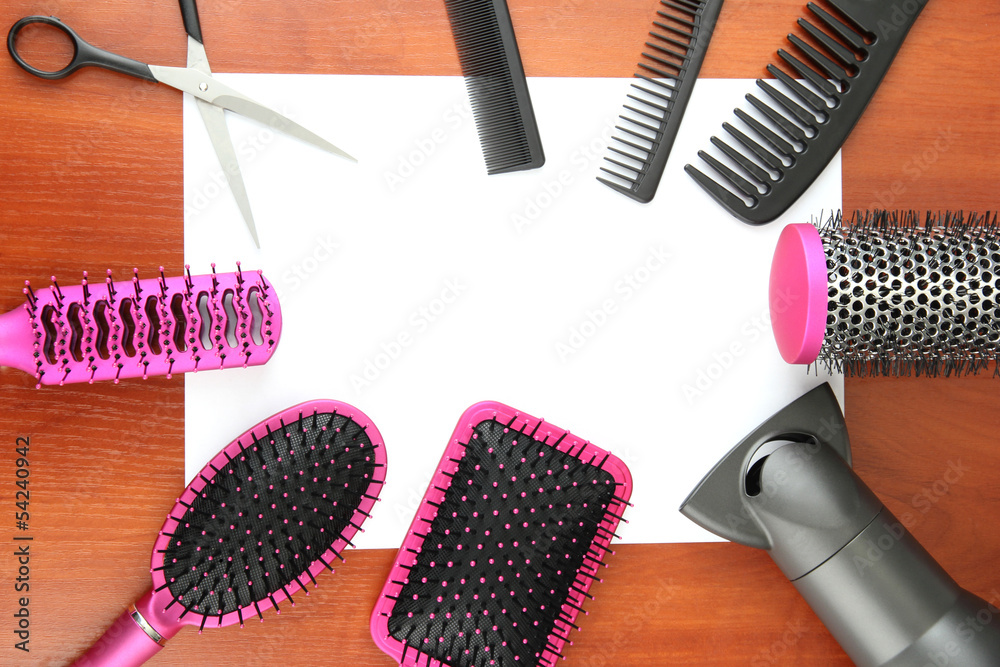 Comb brushes, hairdryer and cutting shears,on wooden background
