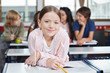 © Tyler Olson - Schoolgirl Smiling While Leaning On Desk
