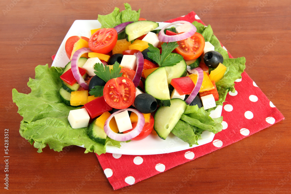 Tasty Greek salad on wooden background