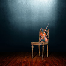 Old Chair And Violin In An Empty Room.