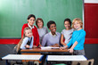 © Tyler Olson - Happy Teacher And Schoolchildren Together At Desk In Classroom