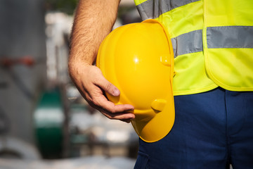 man holding yelow helmet