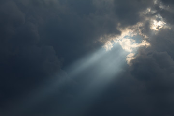Wall Mural - stormy sky with a dramatic sunbeam
