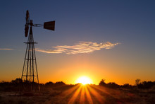 Lovely Sunset In Kalahari With Windmill And Grass