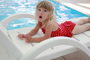 girl in the water pool on a sun lounger