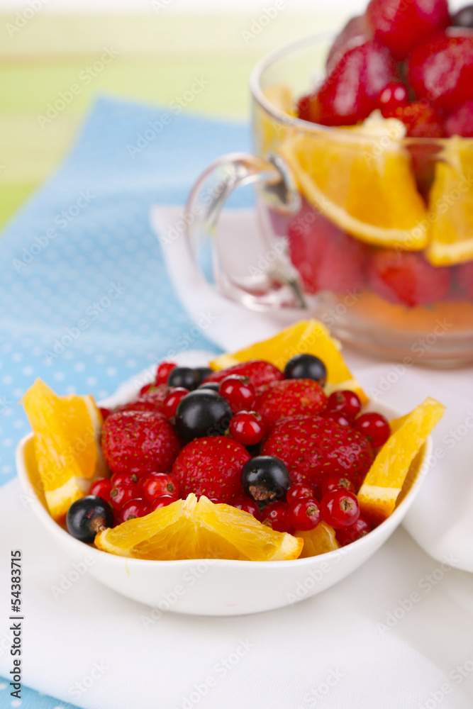 Useful fruit salad in glass cup and bowl