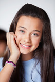 Fototapeta Na ścianę - Beautiful Teenage Schoolgirl In Smiling Classroom