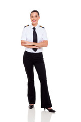 Wall Mural - female young airline co-pilot with arms crossed