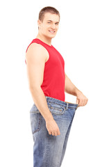 Sticker - Satisfied weight less man in an old pair of jeans looking at cam