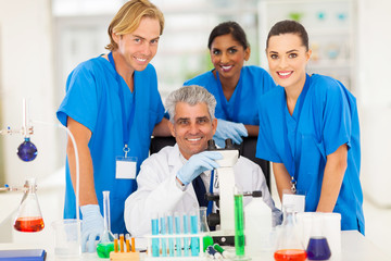 Wall Mural - senior scientist with group of chemistry students