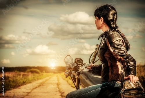 Fototapeta na wymiar Biker girl on a motorcycle