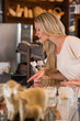 © Milles Studio - Happy young woman selecting bread from display cabinet of bakery